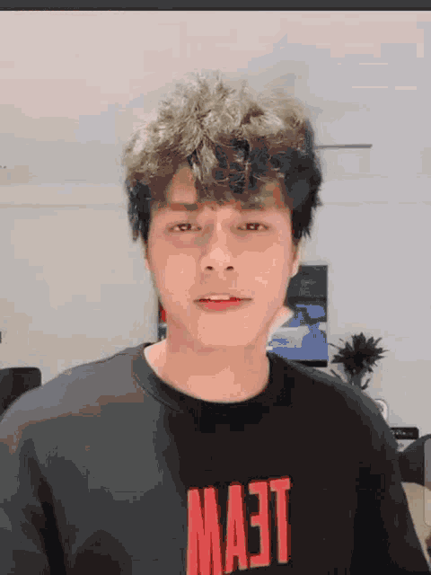 a young man wearing a black shirt that says mast