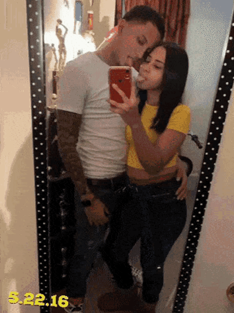 a man and woman taking a selfie in front of a mirror with the date 5.22.16 on the bottom