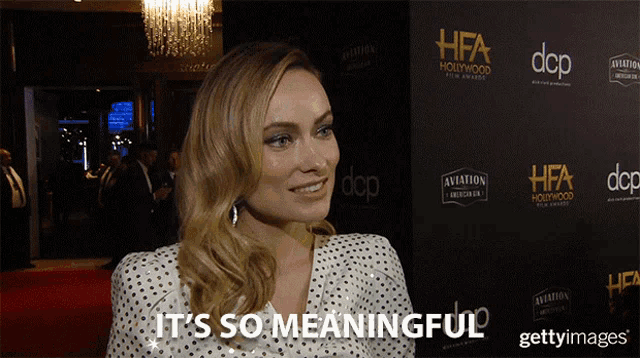 a woman says it 's so meaningful in front of a wall that says hfa