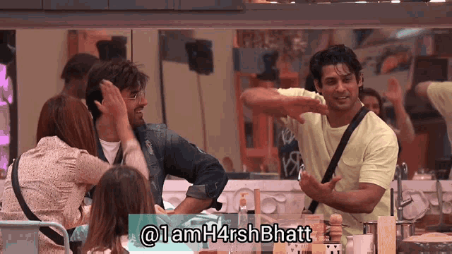 a group of people are sitting around a table with a sign that says @ 1amh4rsh bhatt