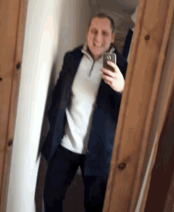 a man taking a picture of himself in the mirror