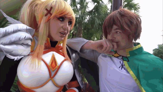 a man and a woman are standing next to each other and the woman has a cross on her hair