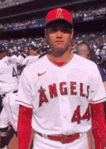 a baseball player wearing a white angels jersey