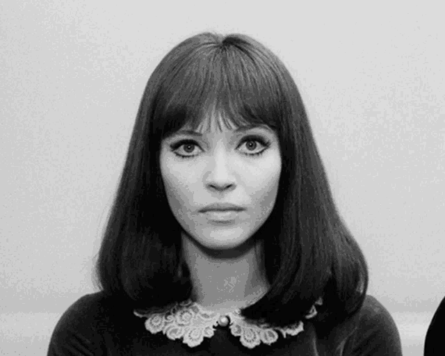 a black and white photo of a woman wearing a collar