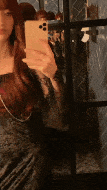 a woman is taking a selfie with her phone in front of a mirror