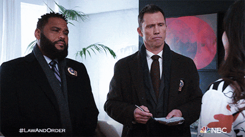 two men standing next to each other with a nbc logo on the bottom left