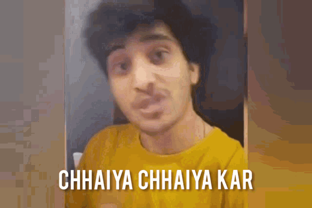 a man in a yellow shirt with the words chhaiya chhaiya kar on the bottom