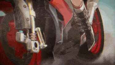 a close up of a person riding a motorcycle with a red wheel