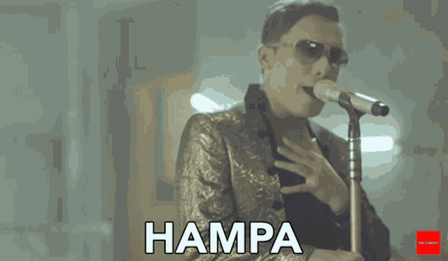 a man singing into a microphone with the word hampa written below him