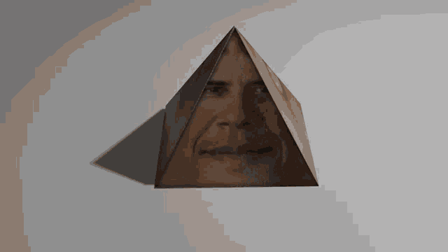 a pyramid shaped object with a face on it