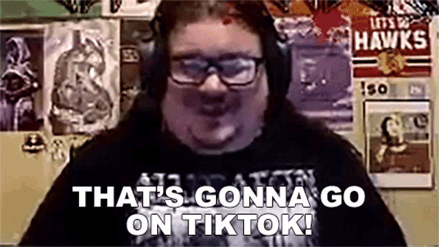a man wearing headphones and glasses is saying that 's gonna go on tiktok