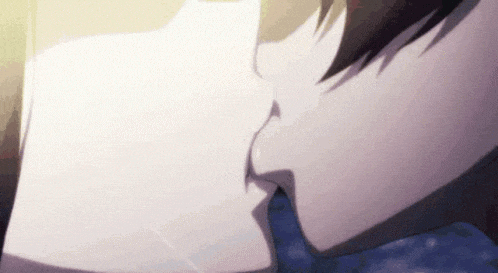 a man and a woman are kissing in a close up of their lips .
