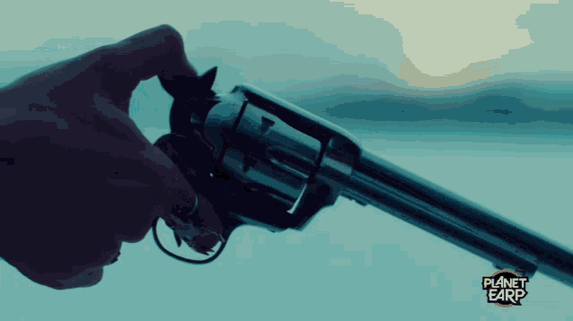 a close up of a person holding a gun with planet earth written on the bottom