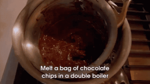 a pot of chocolate chips is being melted in a double boiler