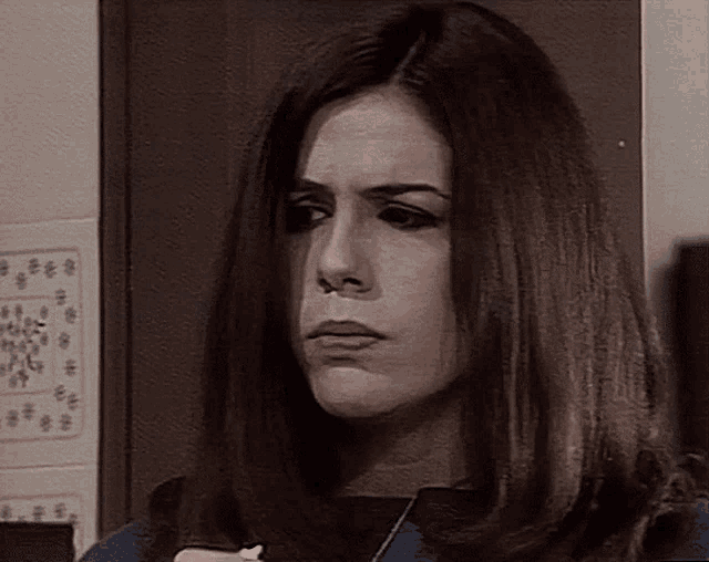 a close up of a woman 's face with a serious look on her face