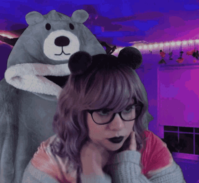 a woman wearing glasses and a teddy bear hooded jacket