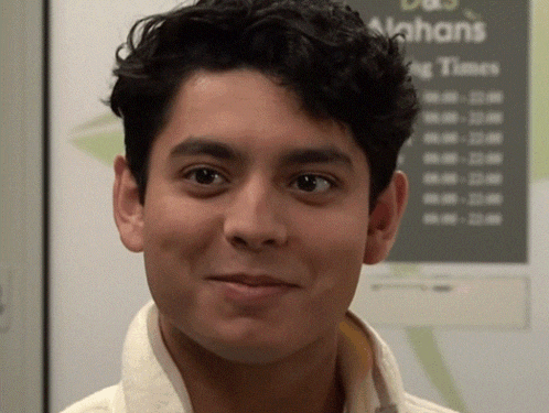 a close up of a man 's face in front of a sign that says alphans