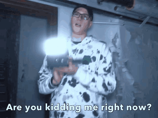 a man holding a flashlight with the words " are you kidding me right now " below him