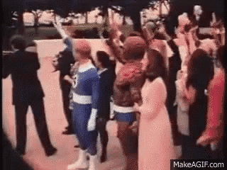 a group of people dressed as superheros are standing next to each other .