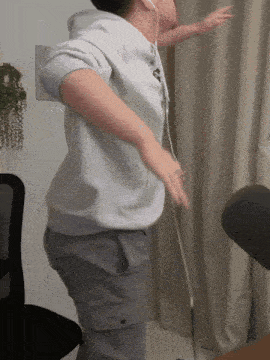 a person wearing headphones is dancing in front of a chair