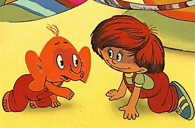 a boy and an elephant are crawling on the ground