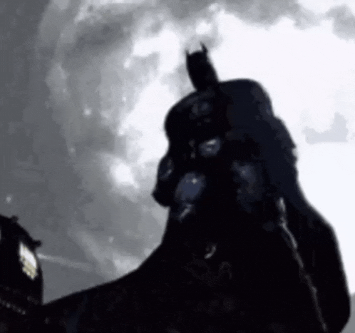 a silhouette of batman standing in front of a full moon in a black and white photo .
