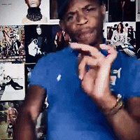 a man wearing a blue shirt with the letter t on it