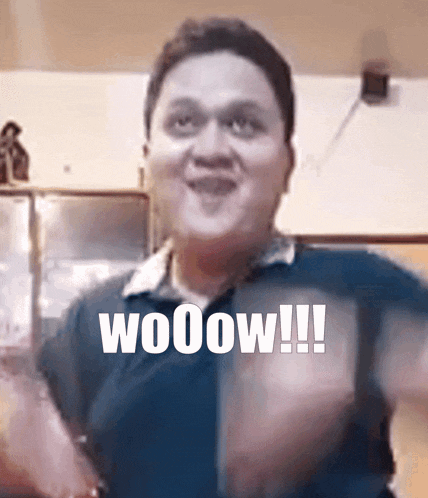 a man wearing a blue shirt with the word wooow on it