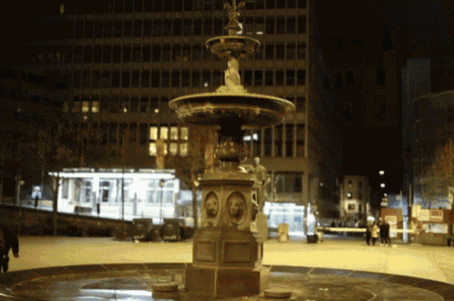 a fountain with a statue of a woman on top