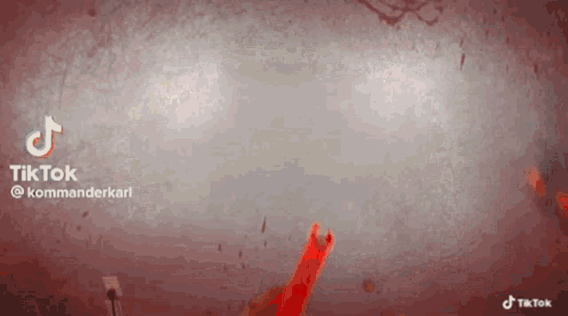 a tiktok video with a bloody background and a red stick