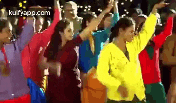 a group of people are dancing together in a crowd .