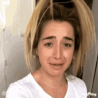 a woman with a bun on her head is crying .