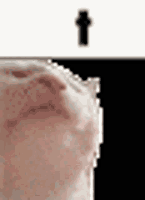 a close up of a person 's face with a black cross in the background .