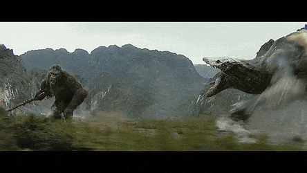 a gorilla and a snake are fighting in a field in front of mountains