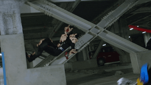 a robot is kicking a car in a parking garage with a license plate that says ' aa ' on it