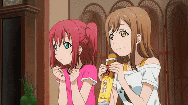 two anime girls are standing next to each other and one of them is holding a yellow item that says ' o'o '