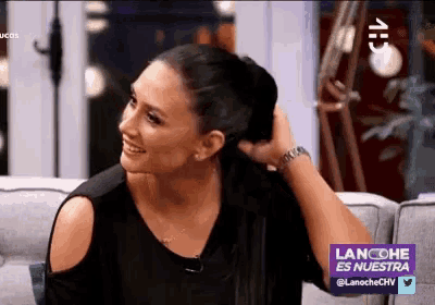 a woman is sitting on a couch with lancoche es nuestra written on the bottom