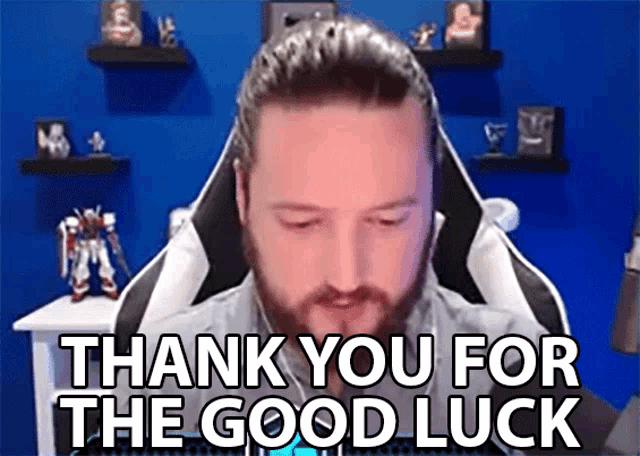 a man with a beard is sitting in a chair and says " thank you for the good luck "