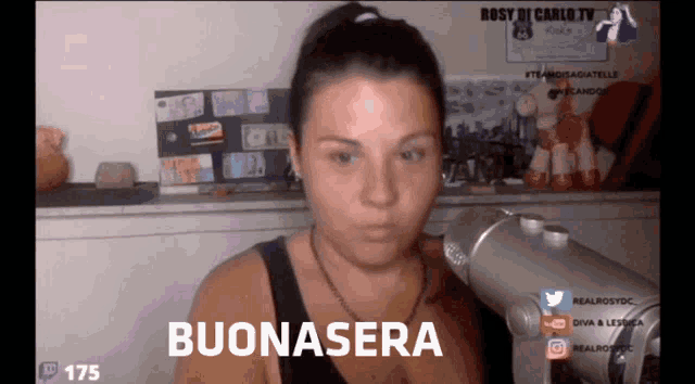 a woman stands in front of a microphone with the words buonasera on the screen