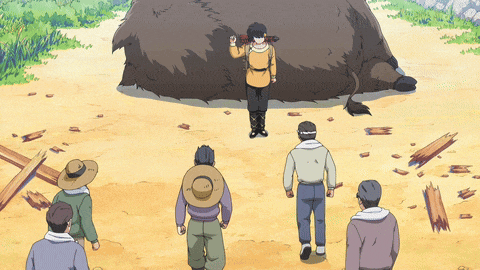 a group of men standing around a large animal