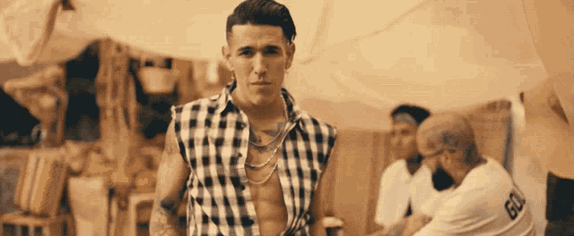 a man in a plaid shirt with the number 60 on the back of his shirt