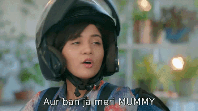 a woman wearing a helmet and headphones says aur ban ja meri mummy