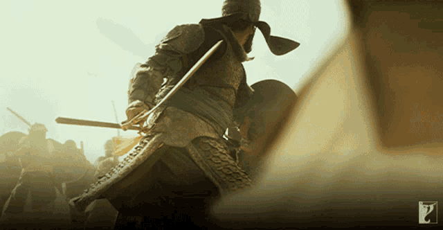 a man in armor is holding a sword in a blurry photo with a question mark in the corner