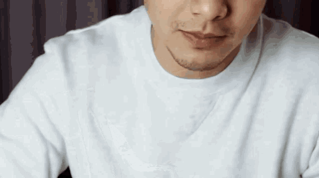 a man with a beard is wearing a white t-shirt