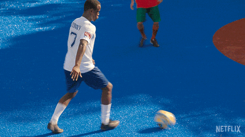 a soccer game is being played in front of a sign that says decathlon