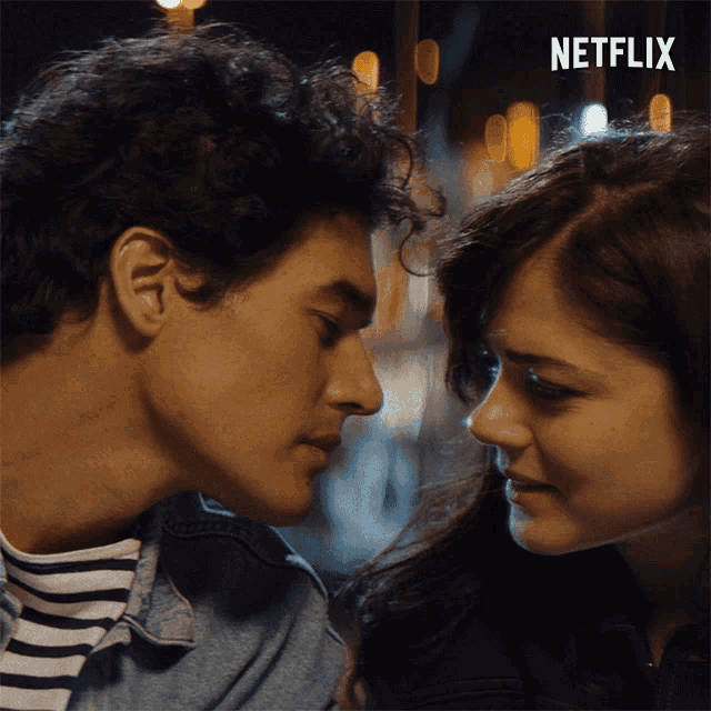 a man and a woman are looking into each other 's eyes with a netflix logo in the corner