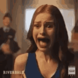 a woman is screaming with her mouth wide open .