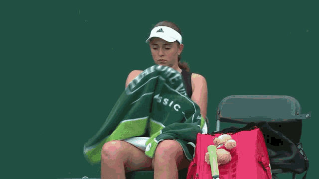 a woman sitting in a chair with a towel that says natreval