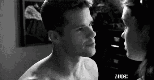 a man and a woman are looking into each other 's eyes .