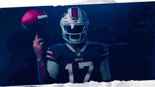a man wearing a buffalo bills jersey is holding a football